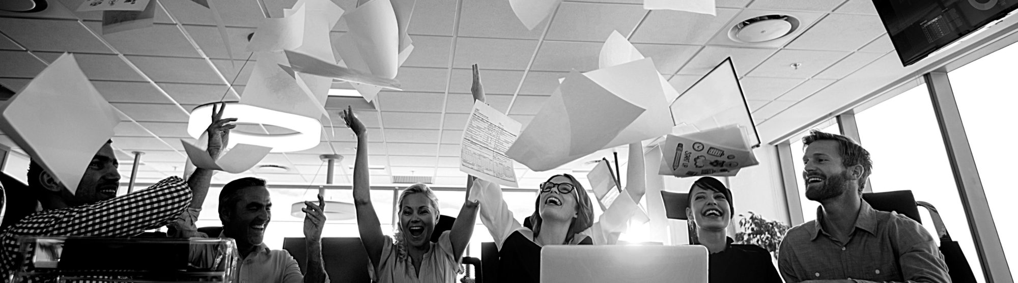 image of happy officeworkers throwing diagram printouts in the air, happy they are replacing Visio 