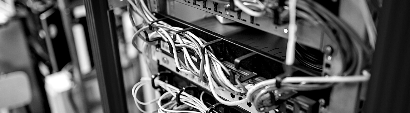 image shows cables coming out of rack devices in a data center