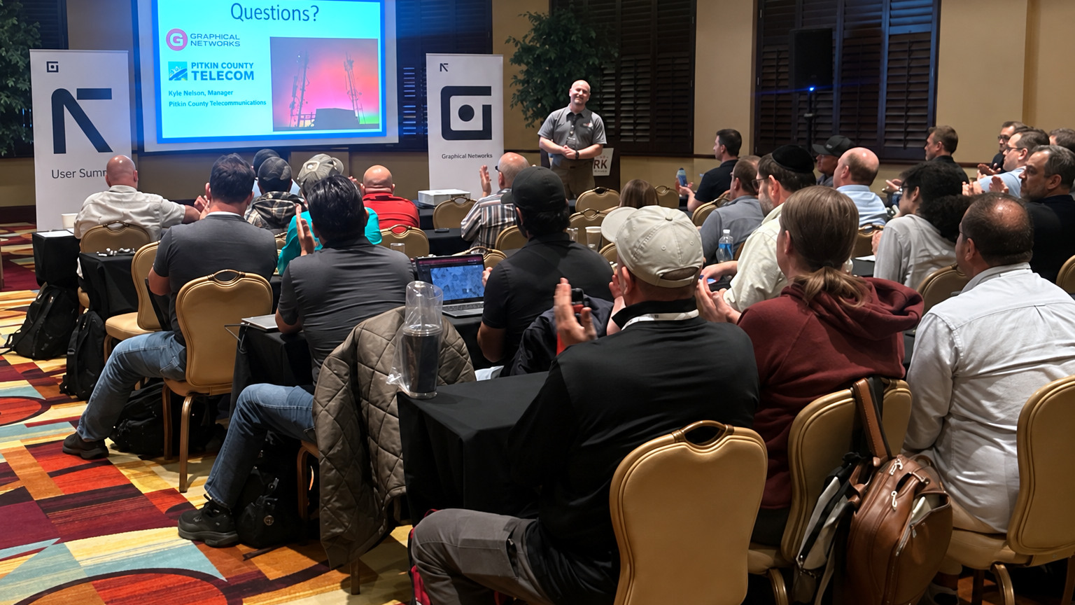 A customer presenting to attendees at the 2026 netTerrain User Summit.