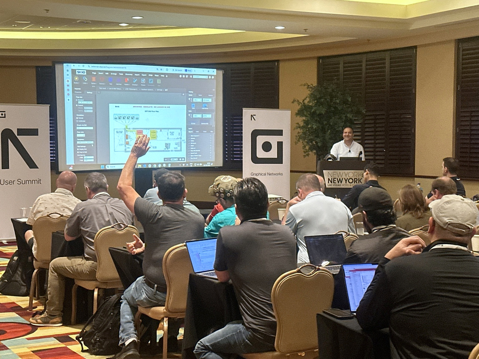 An attendee participating in a customer presentation and discussion at the netTerrain User Summit.